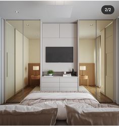 a bedroom with mirrored closet doors and a flat screen tv mounted on the wall above it