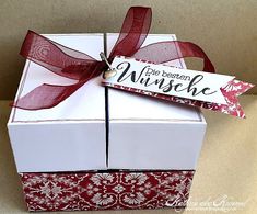 a white box with red ribbon tied around it that says, the best is nibble