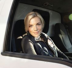 a woman sitting in the passenger seat of a car