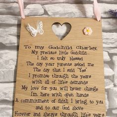 a wooden plaque with a poem written in the shape of a heart and two butterflies