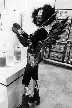 a woman dressed in costume standing next to a counter