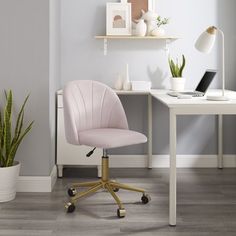 a pink office chair sitting in front of a white desk