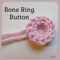 a pink crochet knot with the words bone ring button