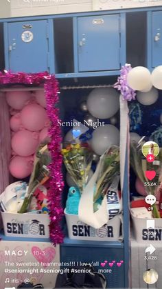 a blue locker with balloons, flowers and other items in it's display area