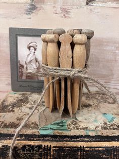 an old book with some wooden people on it and a rope attached to the cover