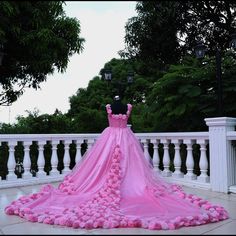 a dress made out of pink flowers on a balcony