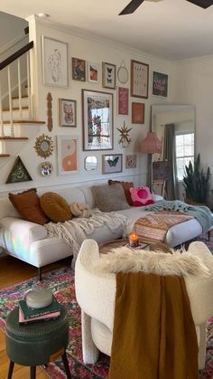 a living room filled with furniture and pictures on the wall