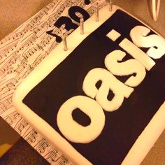 a sheet cake with the word boss on it and music notes in the back ground