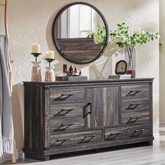 a dresser with drawers and a mirror above it