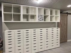 a large white cabinet with lots of drawers