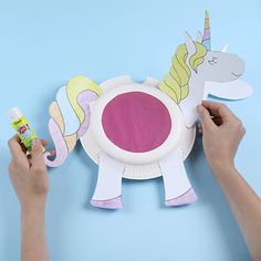 someone is making a paper plate unicorn craft