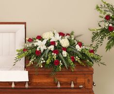 a casket with red and white flowers on it