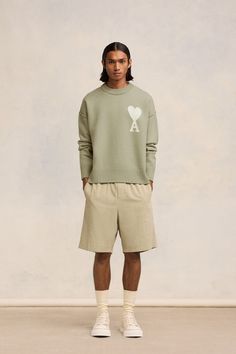 sage green wool ribbed trim signature Ami de Coeur monogram motif crew neck long sleeves straight hem When buying this unisex item, keep in mind that it is graded in standard men's sizing. This item is certified to high animal welfare standards, ensuring that no animals have been subjected to any unnecessary harm for the purposes of making this item and that there is traceability in the supply chain. Learn more about what makes a product Conscious on our Conscious Criteria page Ami Paris Outfit, Sage Green Outfit, Sweaters And Cardigans, Look Short, Paris Outfits, Ami Paris, Green Outfit, Green Wool, Animal Welfare