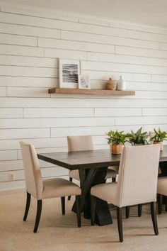 A dining room with a shiplap accent wall, white furniture, and decor for a rustic yet modern vibe. Shiplap Accent Wall, Beautiful Dining Rooms