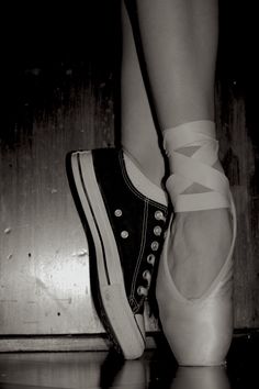 black and white photograph of woman's feet in ballet shoes