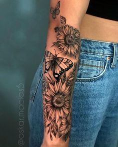 a woman's arm with sunflowers and butterflies on it