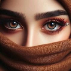 a woman's eyes are covered with a brown scarf