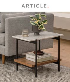 a living room with a gray couch and coffee table on top of it, the text reads how to style an end table article