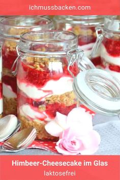 some jars filled with food and flowers on top of a table