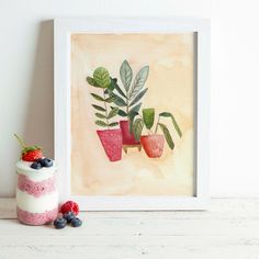 three potted plants are displayed in front of a white frame with berries and raspberries