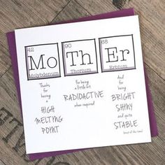 a card with the words mottn fe and its atomic symbols on it sitting on a wooden surface