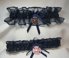 two garters with ribbons and badges on them