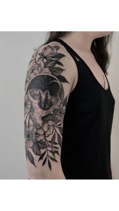 a woman with a black and white tattoo on her arm