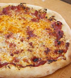 a pizza sitting on top of a wooden cutting board