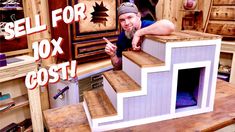 a man sitting on top of a wooden dog house