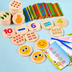 children's wooden numbers and magnets on a blue table with colored pencils