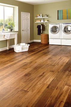 a washer and dryer in a room with wood floors