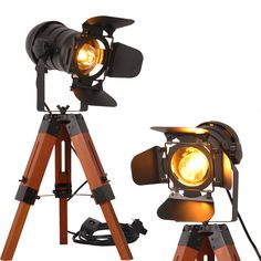 an old fashioned camera and tripod light set up on a tripod with wooden legs