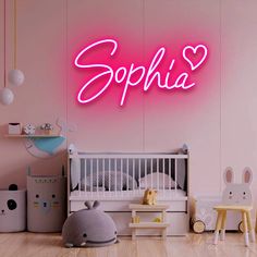 there is a pink neon sign that says sophiia on the wall in this child's room