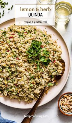 lemon and herb quinoa on a white plate with spoons next to it