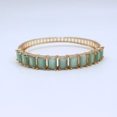 Enhance your jewelry collection with our stunning aqua chalcedony gemstone gold bangle bracelet. This elegant piece is perfect for any occasion, adding a touch of sophistication to your look. ✨ Handcrafted with precision and care 💎 Features genuine aqua chalcedony gemstones 🌟 Gold-plated for a luxurious finish 🎁 Ideal gift for birthdays, anniversaries, and special occasions 🛍️ Versatile accessory suitable for both casual and formal wear 📏 Adjustable size for a comfortable fit 💎 High-quality materials ensure lasting beauty Perfect for treating yourself or as a thoughtful gift, this handmade bangle bracelet is a timeless addition to any jewelry collection. - Material: Aqua Chalcedony Quartz, Gold Plating - Weight : 15gm - Stone Shape: Rectangular - Stone Color: Aqua Green - Bracelet Di Handmade Bangle Bracelets, Gemstone Bangle, Gold Plated Bangles, The Bangles, Aqua Chalcedony, Wedding Jewelry Bracelets, Gold Bangle Bracelet, Quartz Rose, Bracelet Handmade