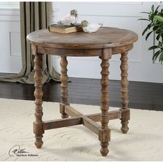 a wooden table sitting on top of a white rug