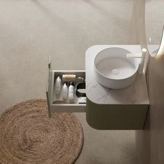 a white sink sitting on top of a bathroom counter next to a toilet paper roll