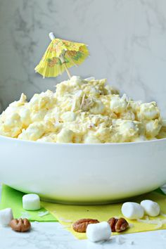 a white bowl filled with marshmallows and an umbrella