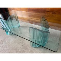 three glass tables with different shapes and sizes on the bottom one is made out of wood