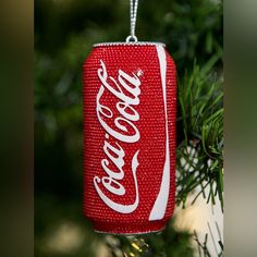 a coca - cola can ornament hanging from a christmas tree