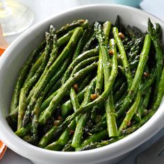 lemon - roasted asparagus in a white bowl