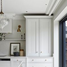 a kitchen with white cabinets and an island