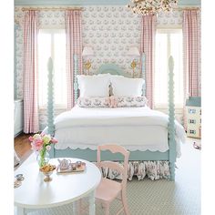 a bedroom with pink and blue decor in it