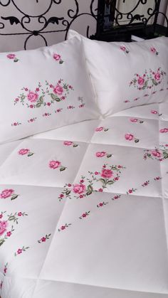 a white bed with pink flowers on it