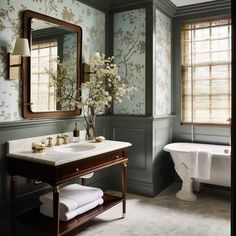 a bathroom with a sink, mirror and bathtub next to a window in it