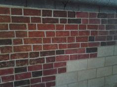 a red brick wall with white and brown bricks