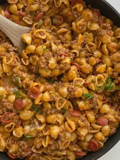 a skillet filled with pasta and meat