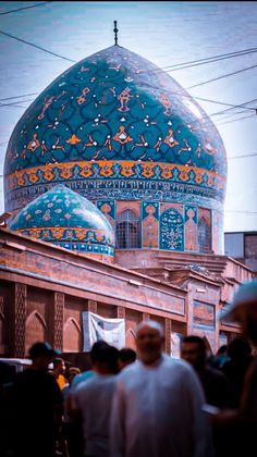 people standing in front of a building with a blue dome