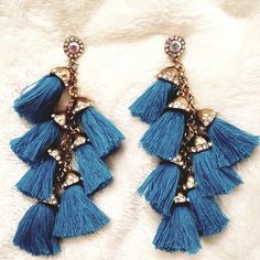 Stunning Cotton Tassel Clusters Hang From A Crystal Halo Stud. The Earrings Are Set Under A Gold Colored Antique Alloy Frame And Adorned With Sparkling Crystals.** Great Gift!!** 3rd Pic For Length Reference (All Gray Is Sold). Materials: Zinc Alloy,Cotton Size: 4.25" Waterfall Earrings, Blue Tassel, Sparkling Crystal, Tassel Necklace, Zinc Alloy, Gold Color, Halo, Tassels, Jewelry Earrings