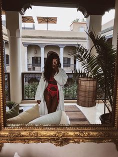 a woman taking a selfie in front of a mirror